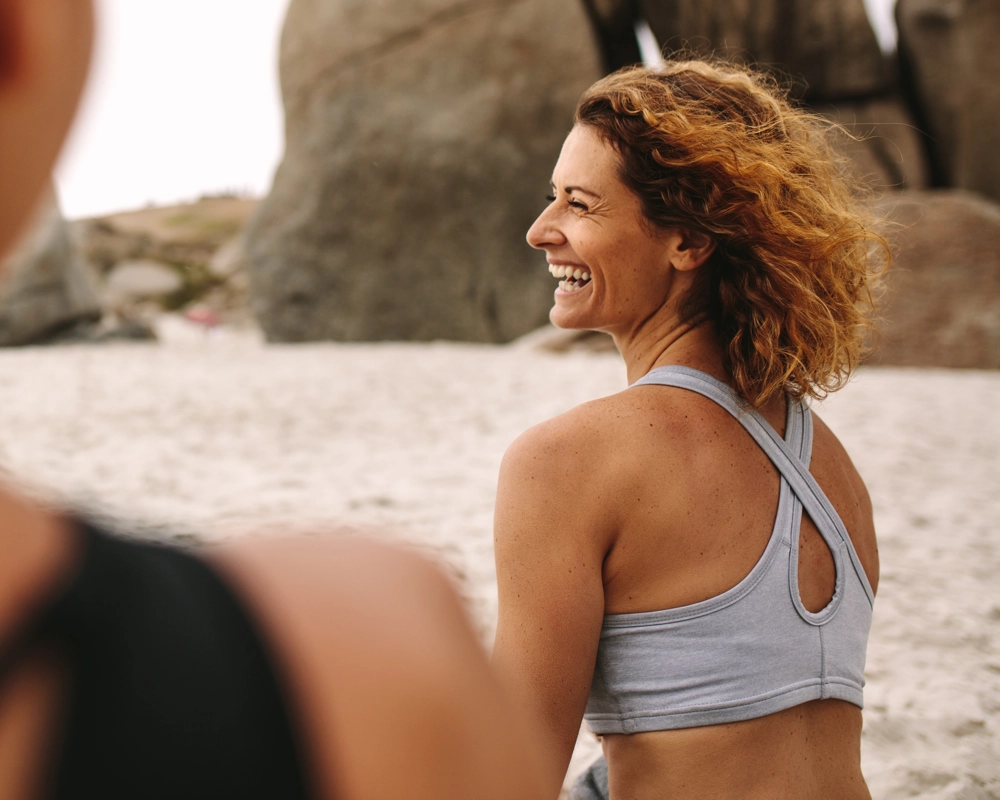 Woman smiling sitting on beach Woman smiling sitting on beach