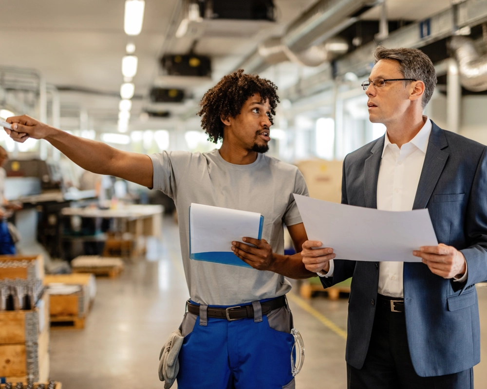 Two people talking about built environment compliance Two people talking about built environment compliance