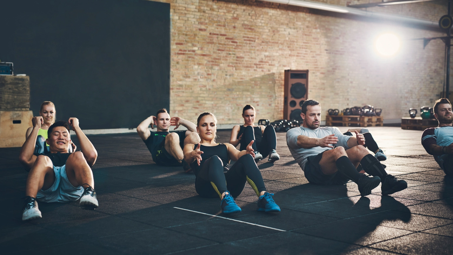 People in gym doing workout class People in gym doing workout class