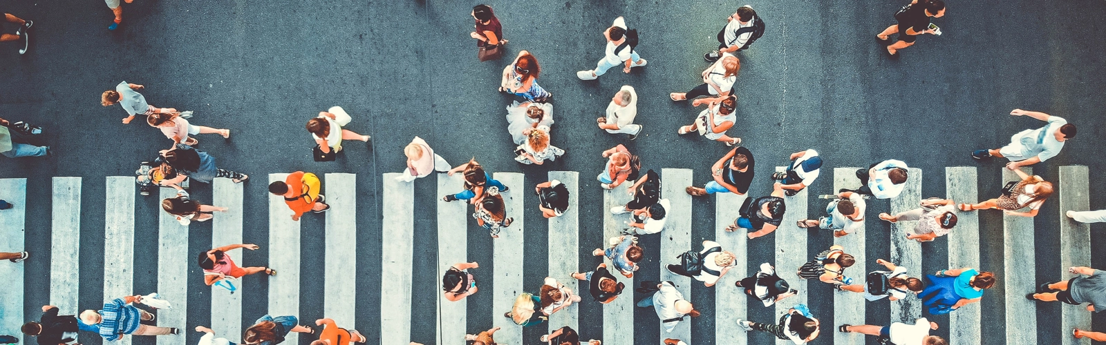 people walking across zebra crossing in shopping district people walking across zebra crossing in shopping district